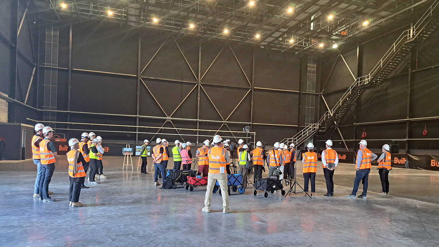 Politicians and the media wearing hi-vis vests and viewing the Perth Films Studios