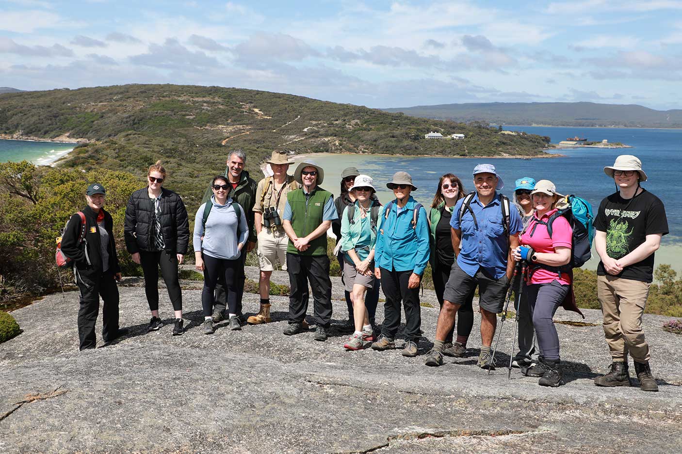 A group of people with the ocean behind them